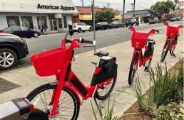 Three red JUMP bikes on University and 4th Ave in San Diego, CA.