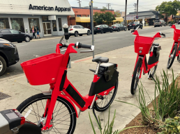 Three red JUMP bikes on University and 4th Ave in San Diego, CA.
